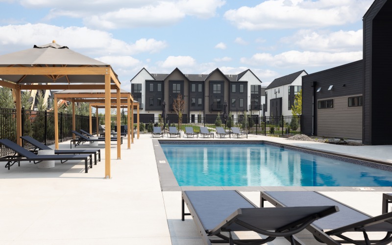 a pool with chairs and umbrellas