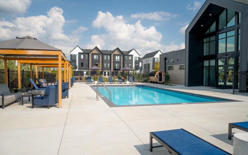 a pool with chairs and umbrellas